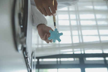 Doctor and patient sitting and talking at medical examination at hospital office, close-up. Therapist filling up medication history records. Medicine and healthcare concept.の写真素材