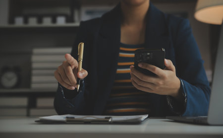 Entrepreneur Asian businessman and businesswoman discussing new business project in tablet in modern Meeting In Modern Office, Asian business casual concept.の写真素材