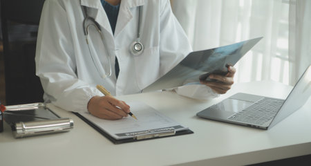 Attractive female doctor make online video call consult patient on laptop. Medical assistant young woman therapist videoconferencing to web camera. Telemedicine concept. Online doctor appointment.の写真素材