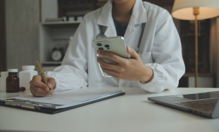 Attractive female doctor make online video call consult patient on laptop. Medical assistant young woman therapist videoconferencing to web camera. Telemedicine concept. Online doctor appointment.の写真素材