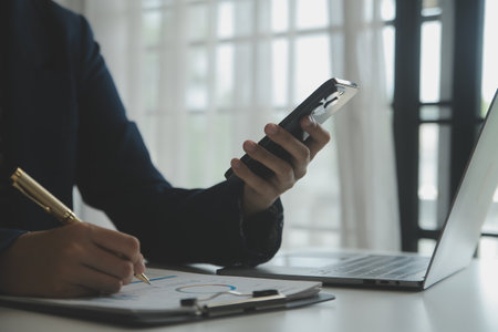 Entrepreneur Asian businessman and businesswoman discussing new business project in tablet in modern Meeting In Modern Office, Asian business casual concept.の写真素材