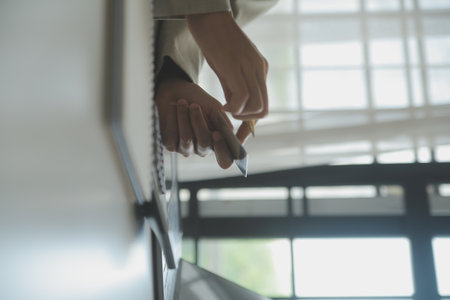 Close up woman hand using credit card and smartphone laptop for buying online shoppingの写真素材