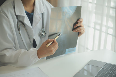 Attractive female doctor make online video call consult patient on laptop. Medical assistant young woman therapist videoconferencing to web camera. Telemedicine concept. Online doctor appointment.の写真素材