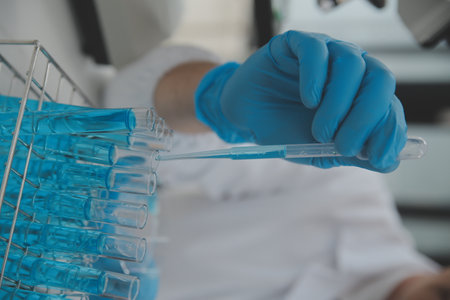 Scientist or medical in lab coat working in biotechnological laboratory, Microscope equipment for...