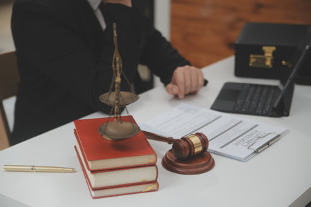 Business and lawyers discussing contract papers with brass scale on desk in office. Law, legal...