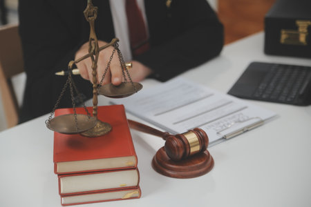 Business and lawyers discussing contract papers with brass scale on desk in office. Law, legal...