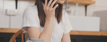 Cropped photo of Freelancer business Asian woman holding coffee cup and at doing planning analyzing the financial report, business plan investment, finance analysis the workplace.の写真素材
