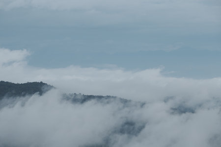 Mountain range with visible silhouettes through the morning blue fog.