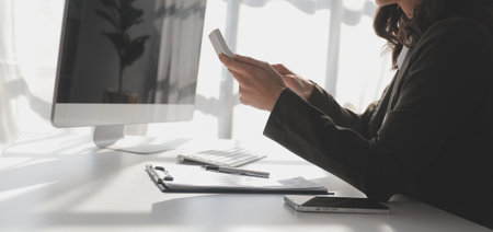 Financial Business woman analyze the graph of the company's performance to create profits and growth, Market research reports and income statistics, data,repotr,Financial and Accounting concept.の写真素材