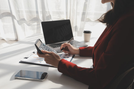 Financial Business woman analyze the graph of the company's performance to create profits and growth, Market research reports and income statistics, data,repotr,Financial and Accounting concept.の写真素材