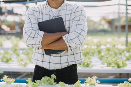 In the Industrial Greenhouse Two Agricultural Engineers Test Plants Health and Analyze Data with...
