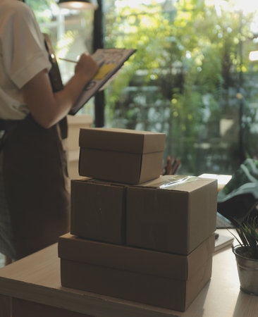 Business woman start up small business entrepreneur SME success .freelance woman working at home with Online Parcel delivery. SME and packaging deliveryconceptの写真素材