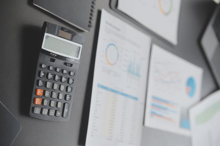 Financial analysts analyze business financial reports on a digital tablet planning investment...