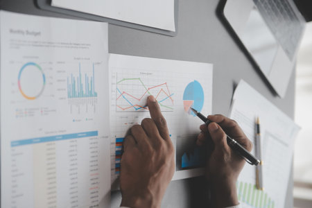 Financial analysts analyze business financial reports on a digital tablet planning investment...