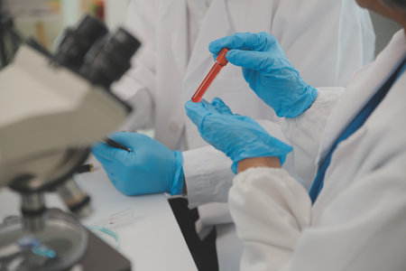Health care researchers working in life science laboratory. Young female research scientist and...