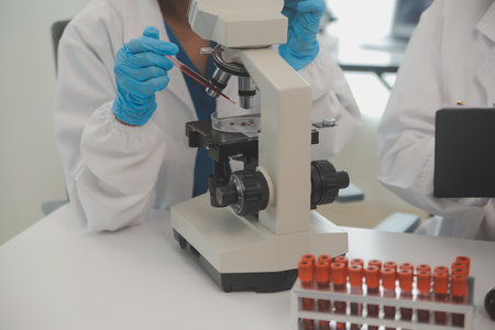 Health care researchers working in life science laboratory. Young female research scientist and...