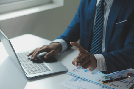 Close up Business woman using calculator and laptop for do math finance on wooden desk, tax, accounting, statistics and analytical research conceptの写真素材
