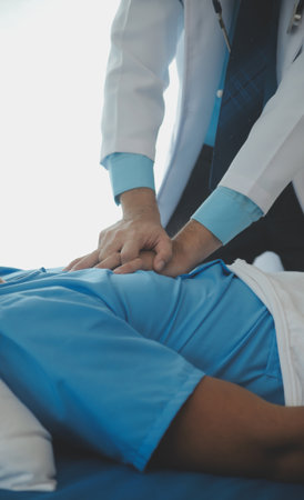 Medical professionals provide assistance to patients with unconscious, using an AED, by placing the...