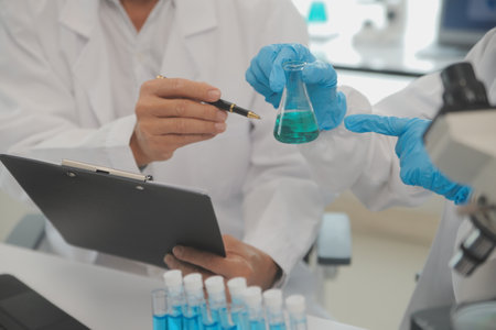 Health care researchers working in life science laboratory. Young female research scientist and...