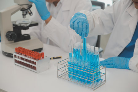 Health care researchers working in life science laboratory. Young female research scientist and...