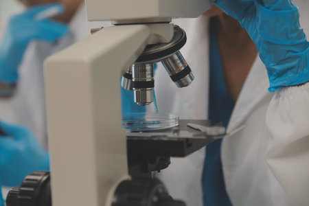 Health care researchers working in life science laboratory. Young female research scientist and...