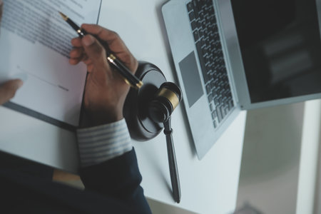 Business and lawyers discussing contract papers with brass scale on desk in office. Law, legal...