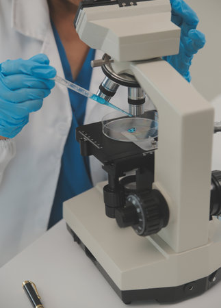 Health care researchers working in life science laboratory. Young female research scientist and...