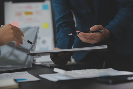 Financial Business team present. Business man hands hold documents with financial statistic stock photo, discussion, and analysis report data the charts and graphs. Finance Financial conceptの写真素材