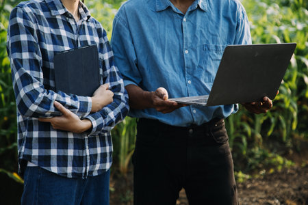 Agriculturist utilize the core data network in the Internet from the mobile to validate, test, and select the new crop method. Young farmers and tobacco farmingの写真素材