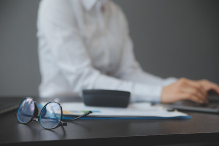 Entrepreneur Asian businessman and businesswoman discussing new business project in tablet in modern Meeting In Modern Office, Asian business casual concept.の写真素材