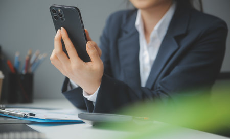 Entrepreneur Asian businessman and businesswoman discussing new business project in tablet in modern Meeting In Modern Office, Asian business casual concept.の写真素材