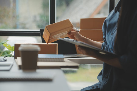 Business woman start up small business entrepreneur SME success .freelance woman working at home with Online Parcel delivery. SME and packaging deliveryconceptの写真素材