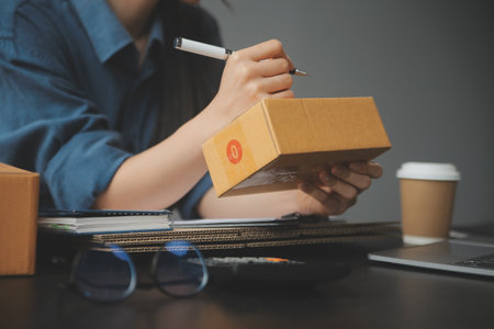 Business woman start up small business entrepreneur SME success .freelance woman working at home with Online Parcel delivery. SME and packaging deliveryconceptの写真素材