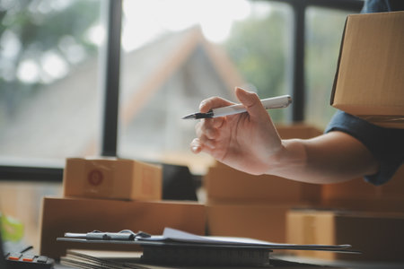 Business woman start up small business entrepreneur SME success .freelance woman working at home with Online Parcel delivery. SME and packaging deliveryconceptの写真素材