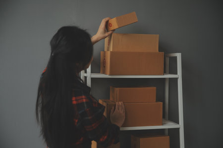 Business woman start up small business entrepreneur SME success .freelance woman working at home with Online Parcel delivery. SME and packaging deliveryconceptの写真素材