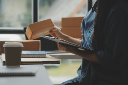 Business woman start up small business entrepreneur SME success .freelance woman working at home with Online Parcel delivery. SME and packaging deliveryconceptの写真素材