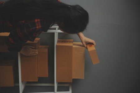 Business woman start up small business entrepreneur SME success .freelance woman working at home with Online Parcel delivery. SME and packaging deliveryconceptの写真素材