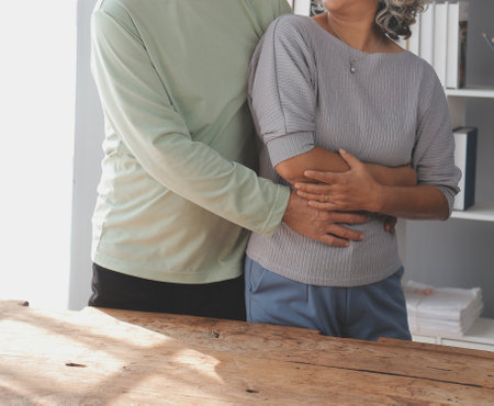 Asian mature senior couple look talk to smartphone camera at home. video calling communicate in online chatの写真素材