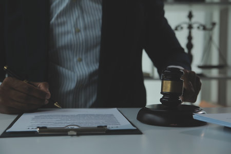 Business and lawyers discussing contract papers with brass scale on desk in office. Law, legal services, advice, justice and law concept picture with film grain effectの写真素材