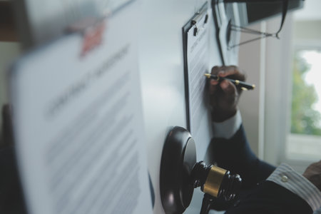 Business and lawyers discussing contract papers with brass scale on desk in office. Law, legal services, advice, justice and law concept picture with film grain effectの写真素材