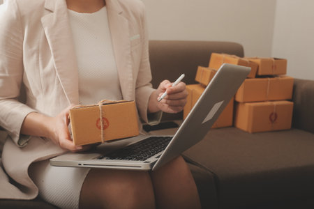 Business woman start up small business entrepreneur SME success .freelance woman working at home with Online Parcel delivery. SME and packaging deliveryconceptの写真素材