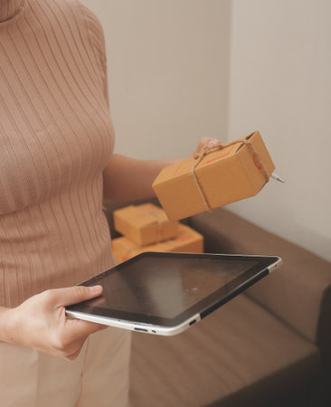 Business woman start up small business entrepreneur SME success .freelance woman working at home with Online Parcel delivery. SME and packaging deliveryconceptの写真素材
