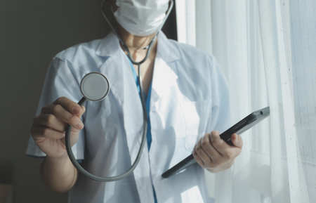 Healthcare and medical concept. Medicine doctor with stethoscope in hand and Patients come to the hospital background.の写真素材
