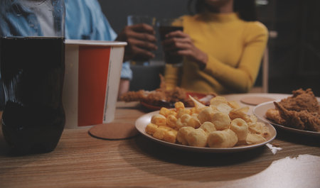 fat woman bite piece of pizza,overweight female is eating fast foods,asian girl is hungryの写真素材