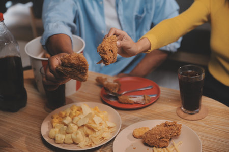 fat woman bite piece of pizza,overweight female is eating fast foods,asian girl is hungryの写真素材