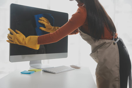 Office Cleaning Service. Janitor Spraying Desk. Workplace Hygiene
