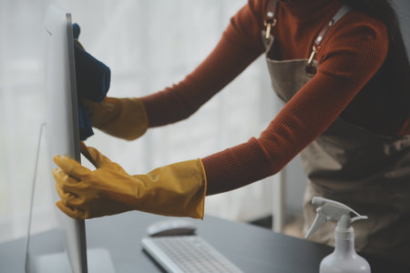 Office Cleaning Service. Janitor Spraying Desk. Workplace Hygieneの写真素材