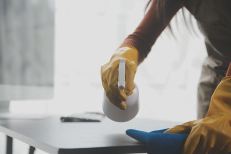 Office Cleaning Service. Janitor Spraying Desk. Workplace Hygieneの写真素材