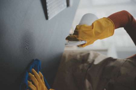 Office Cleaning Service. Janitor Spraying Desk. Workplace Hygieneの写真素材