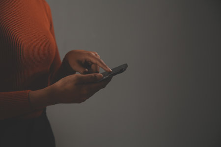 Asian Businesswoman Using laptop computer and working at office with calculator document on desk, doing planning analyzing the financial report, business plan investment, finance analysis concept.の写真素材